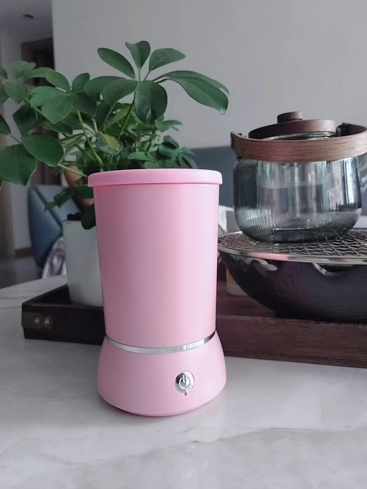 Pink DOGNESS paw washer placed on kitchen counter beside tea kettle
