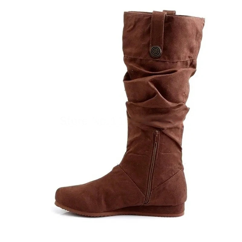 Side view of brown pirate-style slouched boots with zipper and button detail