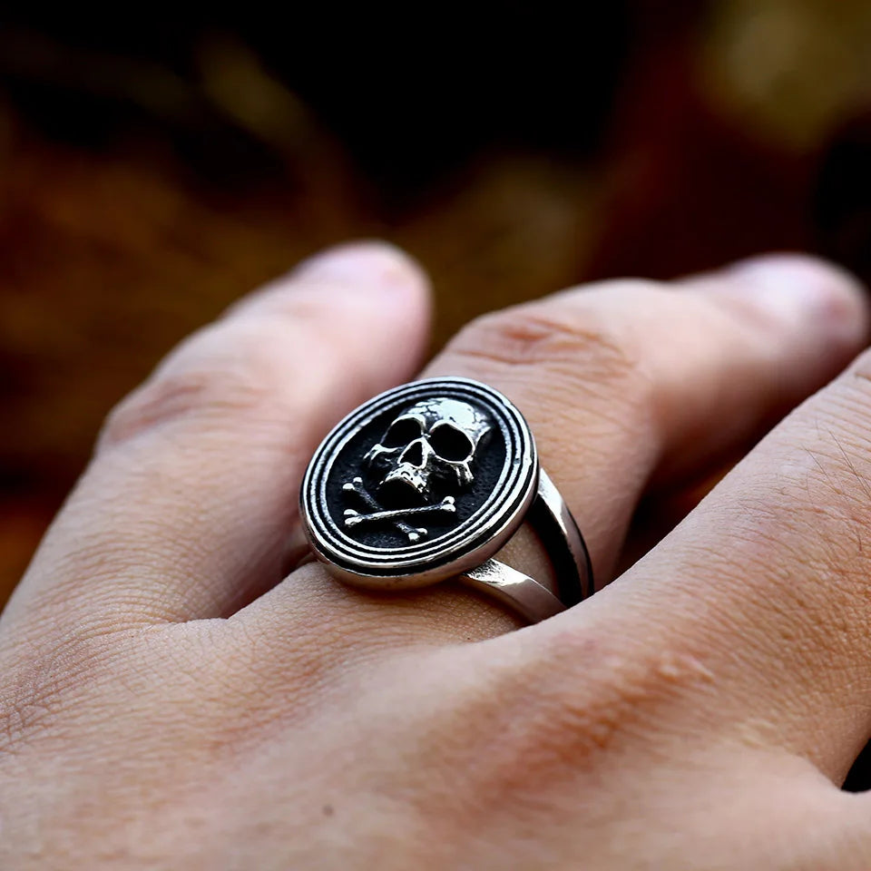 Close-up of The Black Tide ring worn on a finger, highlighting its bold skull and crossbones design.