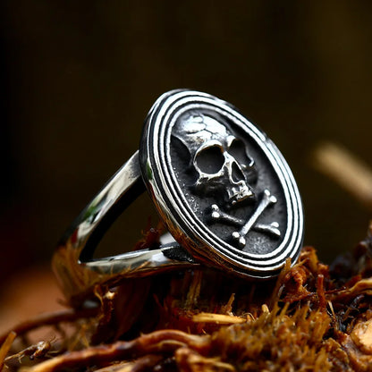 Profile view of The Black Tide ring, emphasizing the skull and crossbones centerpiece and the split band design.