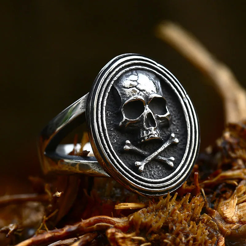 Front view of The Black Tide stainless steel ring featuring an engraved skull and crossbones on an oval face.