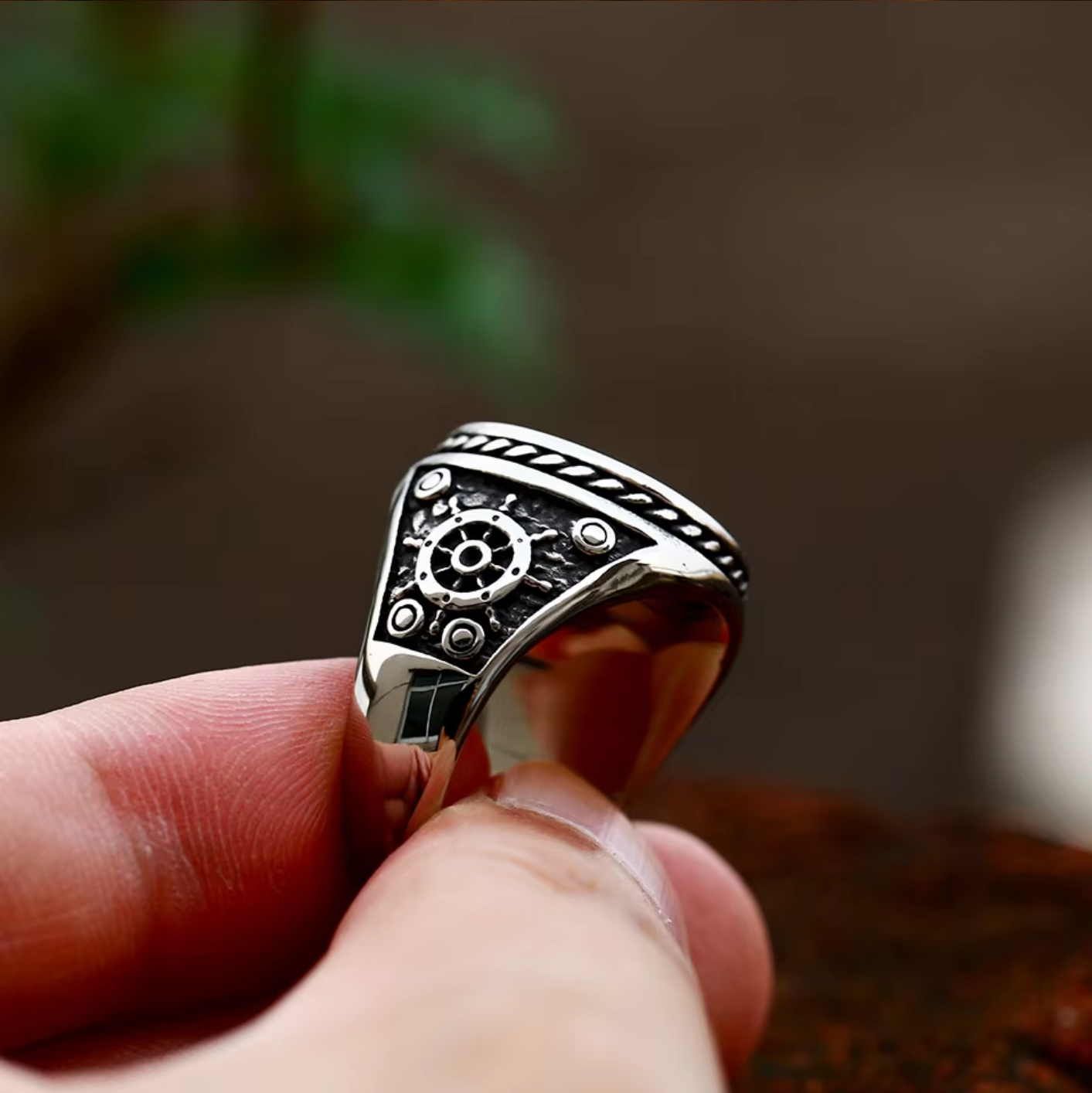 Side view of The Captain's Oath ring highlighting the ship's wheel detail on the side of the band.