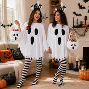Women wearing matching ghost Halloween costumes with BOO headbands and ghost candy bags