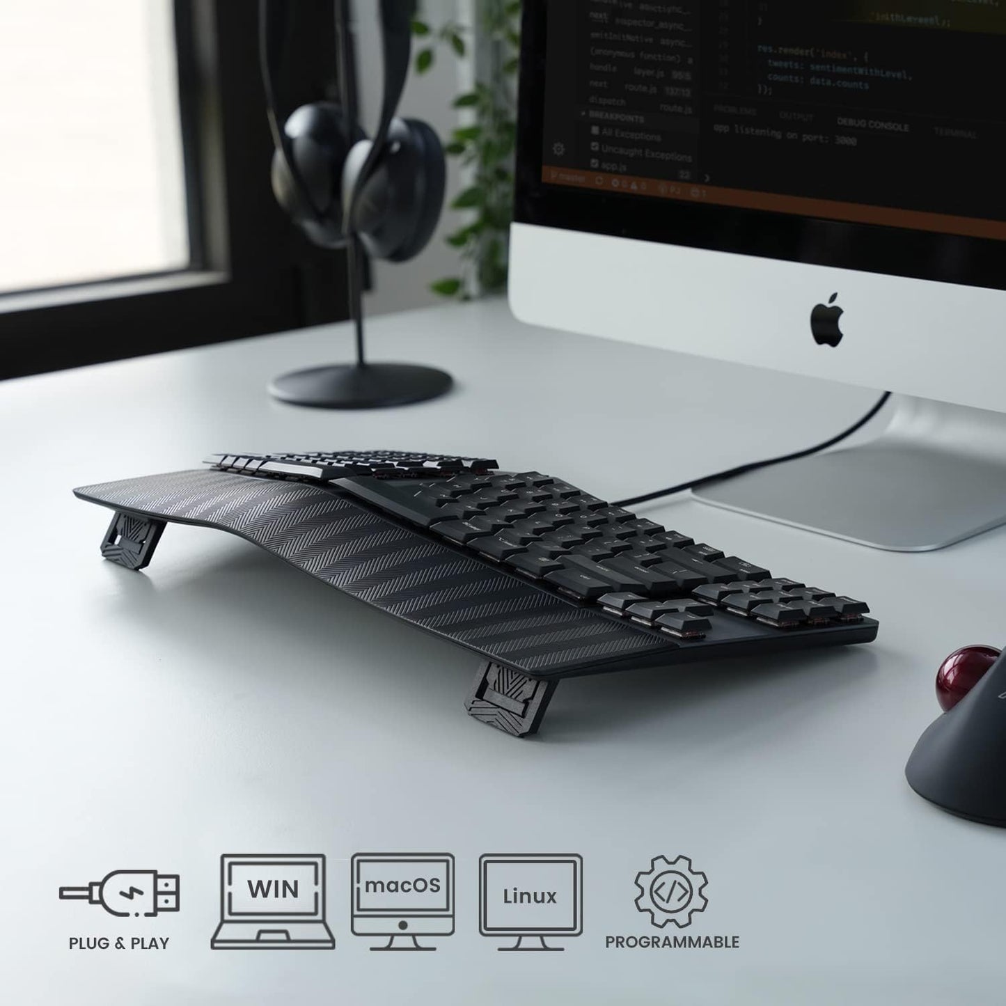 Ergonomic keyboard in use, showing compatibility with Windows, Mac, and Linux systems.