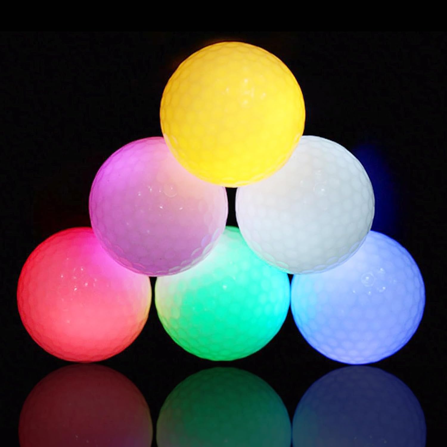 A set of six LED golf balls glowing in different colors, including yellow, green, pink, and blue.