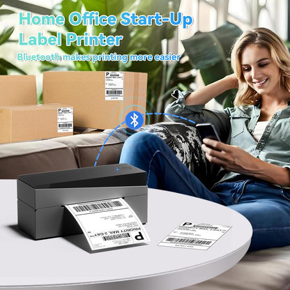 Woman using a Bluetooth label printer with a smartphone in a home office setup for shipping packages.