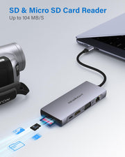 USB-C docking station with SD and micro SD card inserted, transferring data from a camera to a laptop.