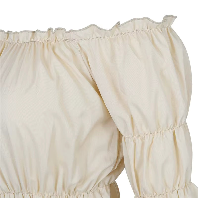 Cream off-shoulder peasant blouse close-up showing ruffled neckline trim and sleeve fabric detail