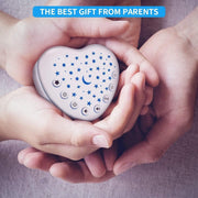 Compact heart-shaped baby white noise machine in parent’s hands