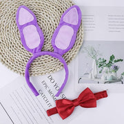 Flat lay of purple rabbit ears headband with red bow tie accessory