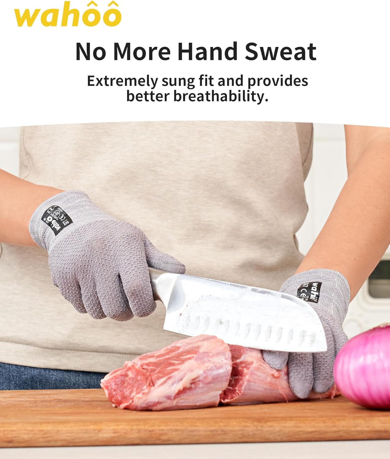 Cut-resistant gloves in use while slicing raw meat on a cutting board.