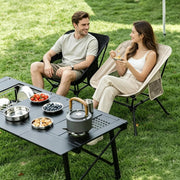 Lightweight camping chairs beside outdoor picnic table