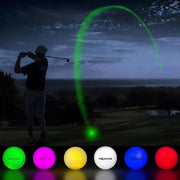 Glowing LED golf ball visible during night golf shot