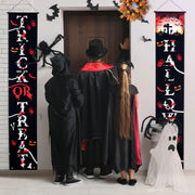 Trick-or-treaters standing near Halloween banners hanging by the front door