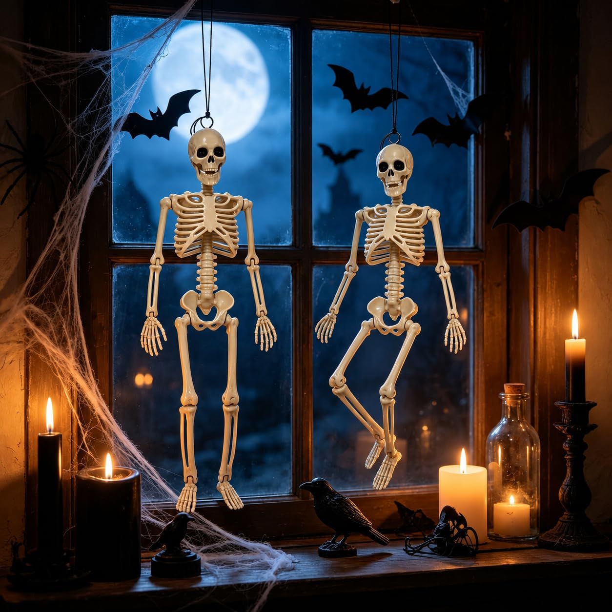 Two hanging Halloween skeletons displayed indoors with spooky decorations