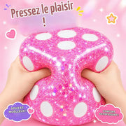 Close-up of hands squeezing a jumbo pink squishy dice fidget toy