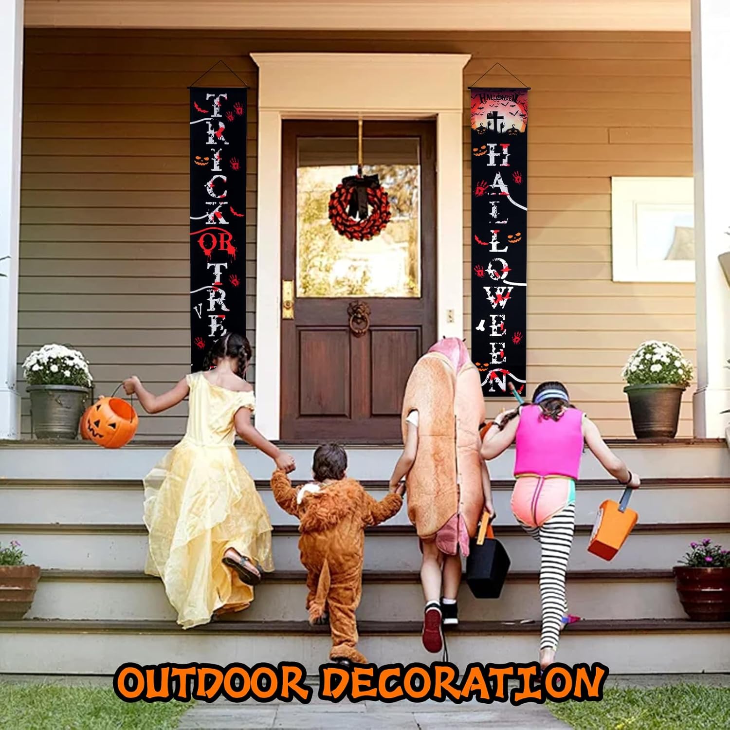 Halloween outdoor decoration with banners on porch entrance and kids in costumes