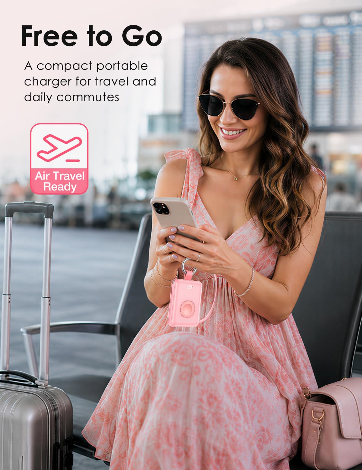 Pink mini portable charger with keyring during air travel