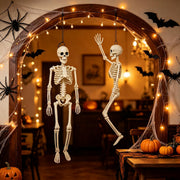Posable hanging Halloween skeleton decorations in a spooky indoor display