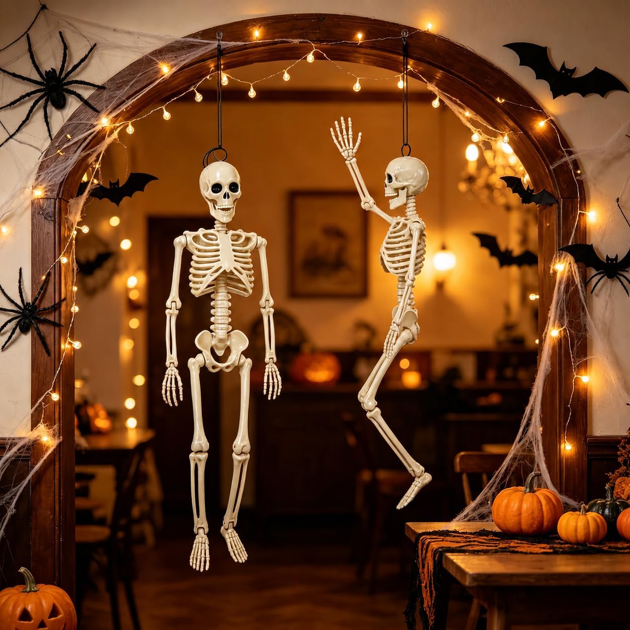 Posable hanging Halloween skeleton decorations in a spooky indoor display