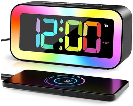 Modern RGB digital alarm clock beside a smartphone charging area