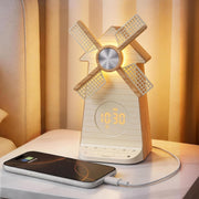 Rotating windmill sunrise alarm clock with USB charging on bedside table