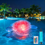 Solar floating turtle pool light glowing red in a swimming pool at night with remote control