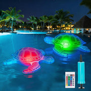 Two glowing inflatable solar turtle pool lights floating in a swimming pool