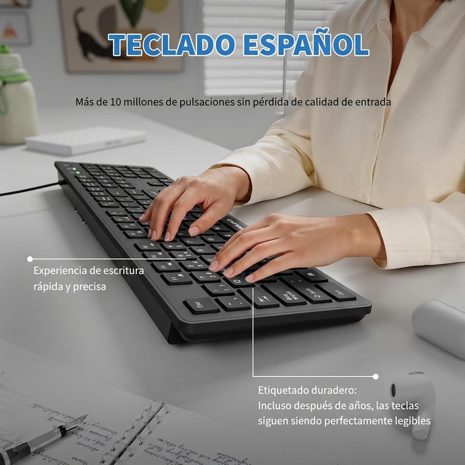 A black wireless computer keyboard shown on a desk with a person typing on it. The image includes Spanish marketing text highlighting the Spanish layout and durable key labeling.