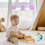 Toddler smiling while playing beside a BPA-free chicken night light.