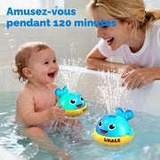 Toddler enjoying 120 minutes of whale sprinkler bath toy fun