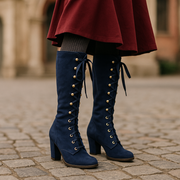 Navy blue retro mid-calf boots with gold eyelets and ribbon laces
