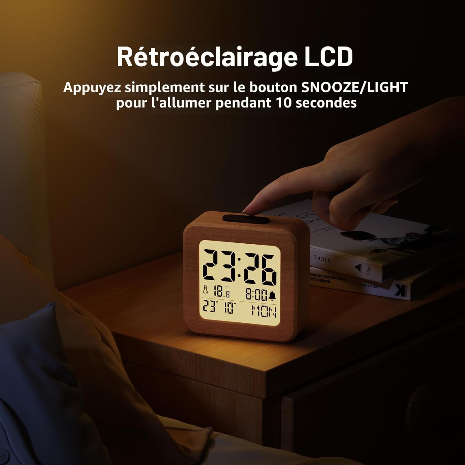Wooden digital alarm clock glowing at night with backlight activated